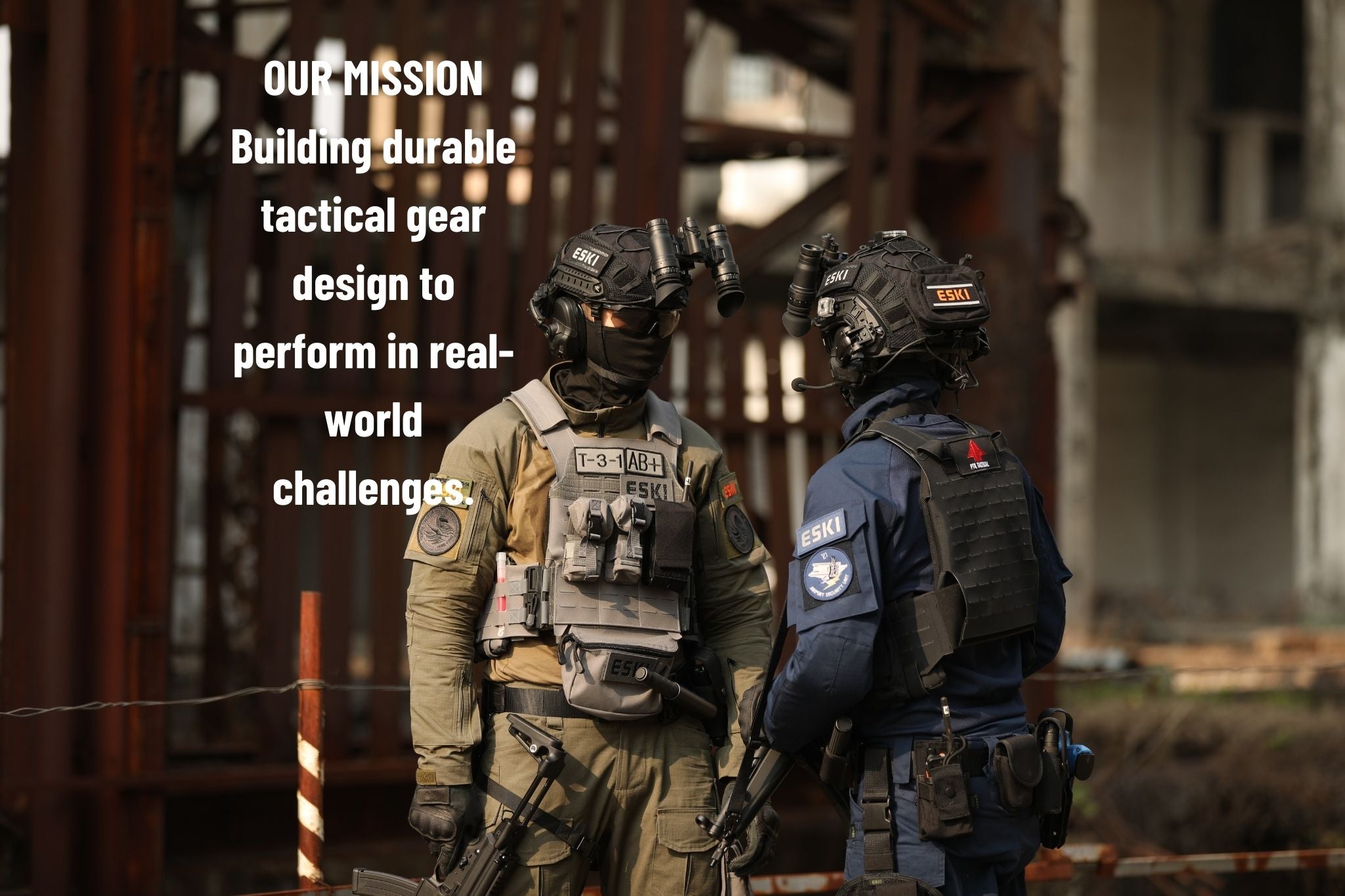 Two tactical operators wearing Eski gear facing each other in an urban training environment with industrial ruins