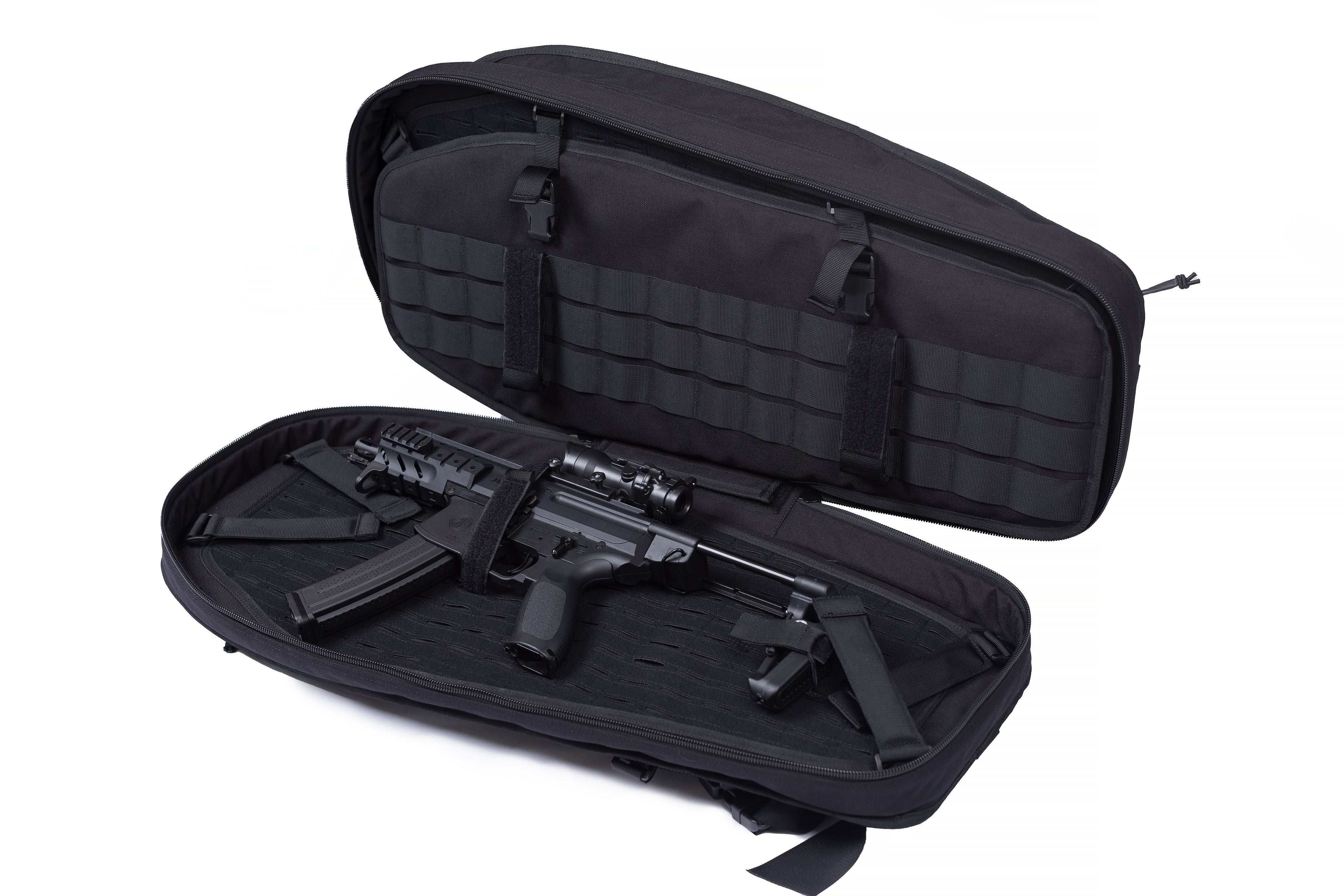 Black tactical carrying case opened to reveal a compact firearm with a collapsible stock, mounted optic sight, and inserted magazine. Interior features MOLLE webbing for securing gear, designed for discreet transport and storage.